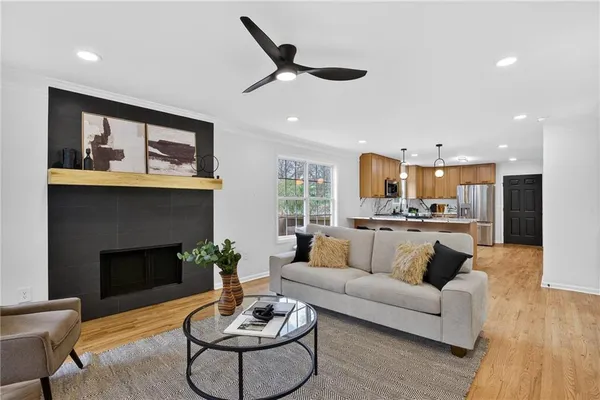 a living room with furniture and a wooden floor
