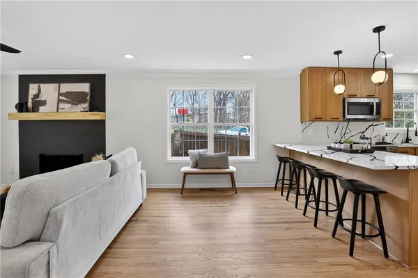 a living room with furniture and a view of kitchen