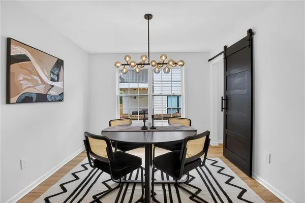 a view of a dining room with furniture and wooden floor