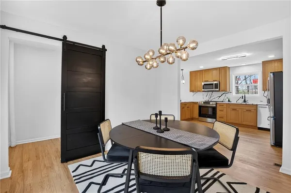 a kitchen with a sink cabinets and a wooden floor