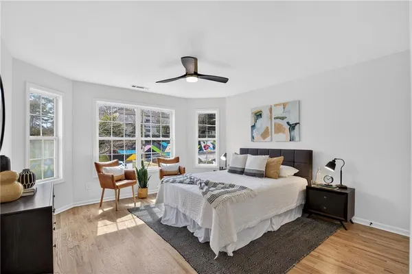 a bedroom with a bed a couch and a window