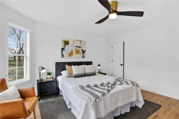 a bedroom with a bed a window and a chandelier