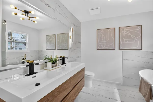 a white bath tub sitting next to a shower