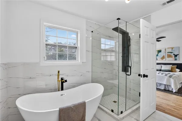 a bathroom with a sink a toilet and a large mirror