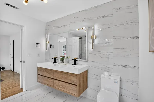 a spacious bathroom with a sink and a mirror