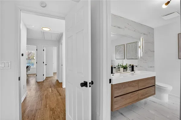 a view of a hallway with wooden floor and closet