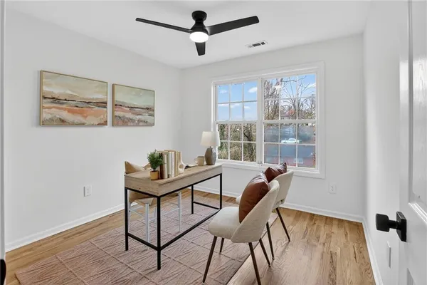 a living room with furniture and wooden floor