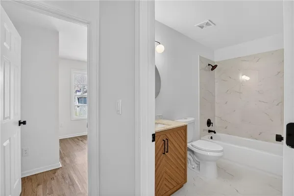 a bathroom with a sink a toilet and a bathtub