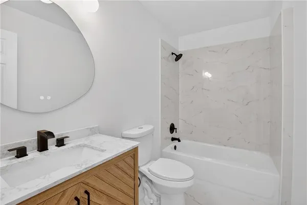 a bathroom with a sink toilet and vanity