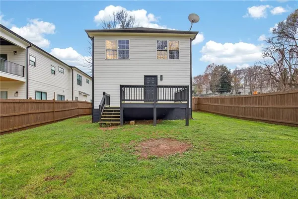 a view of a house with backyard and a tree