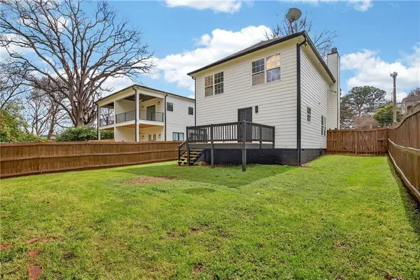 a view of an house with backyard space and balcony