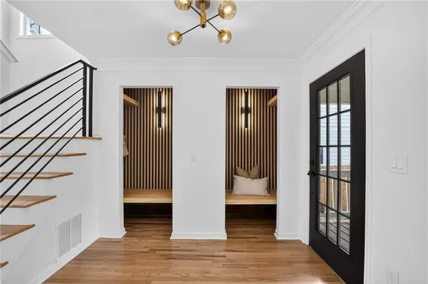a view of a hallway with wooden floor and entryway