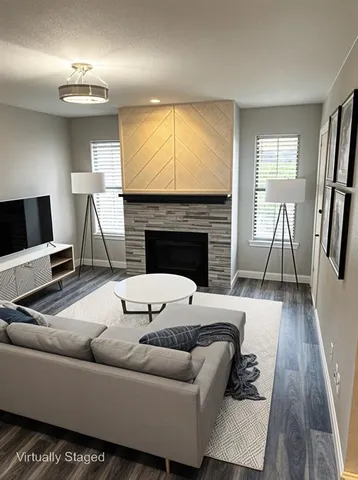 a living room with furniture and a fireplace