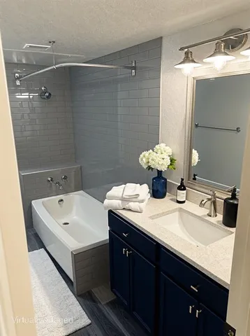 a bathroom with a sink and large mirror
