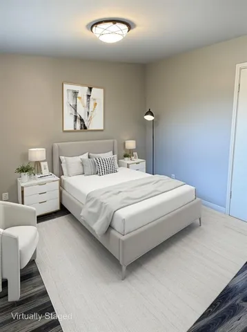 a bedroom with bed and a painting on the wall