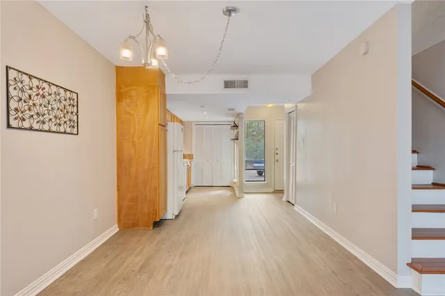 a view of a big room with wooden floor and windows