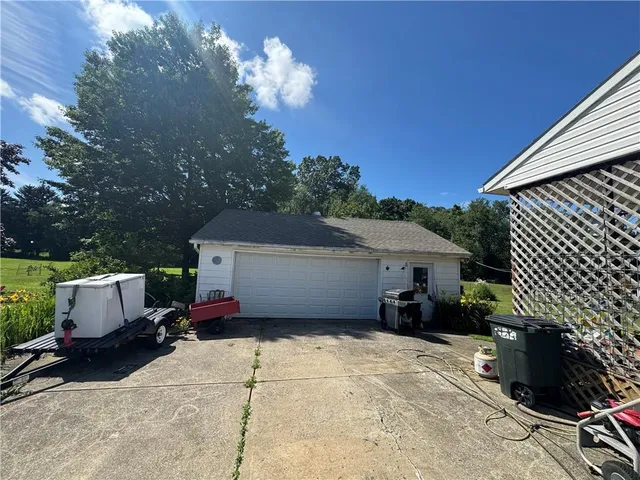 a view of a chairs and tables in the backyard of a house