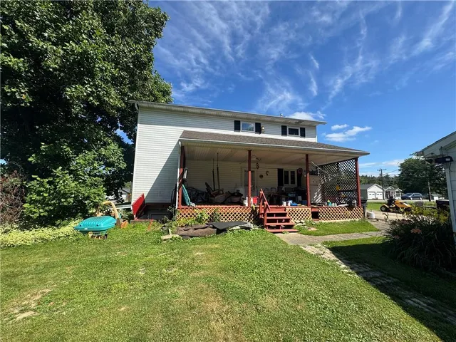 a view of a backyard with table and chairs and a yard