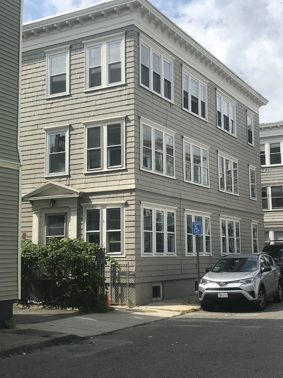 a view of a car parked in front of a building