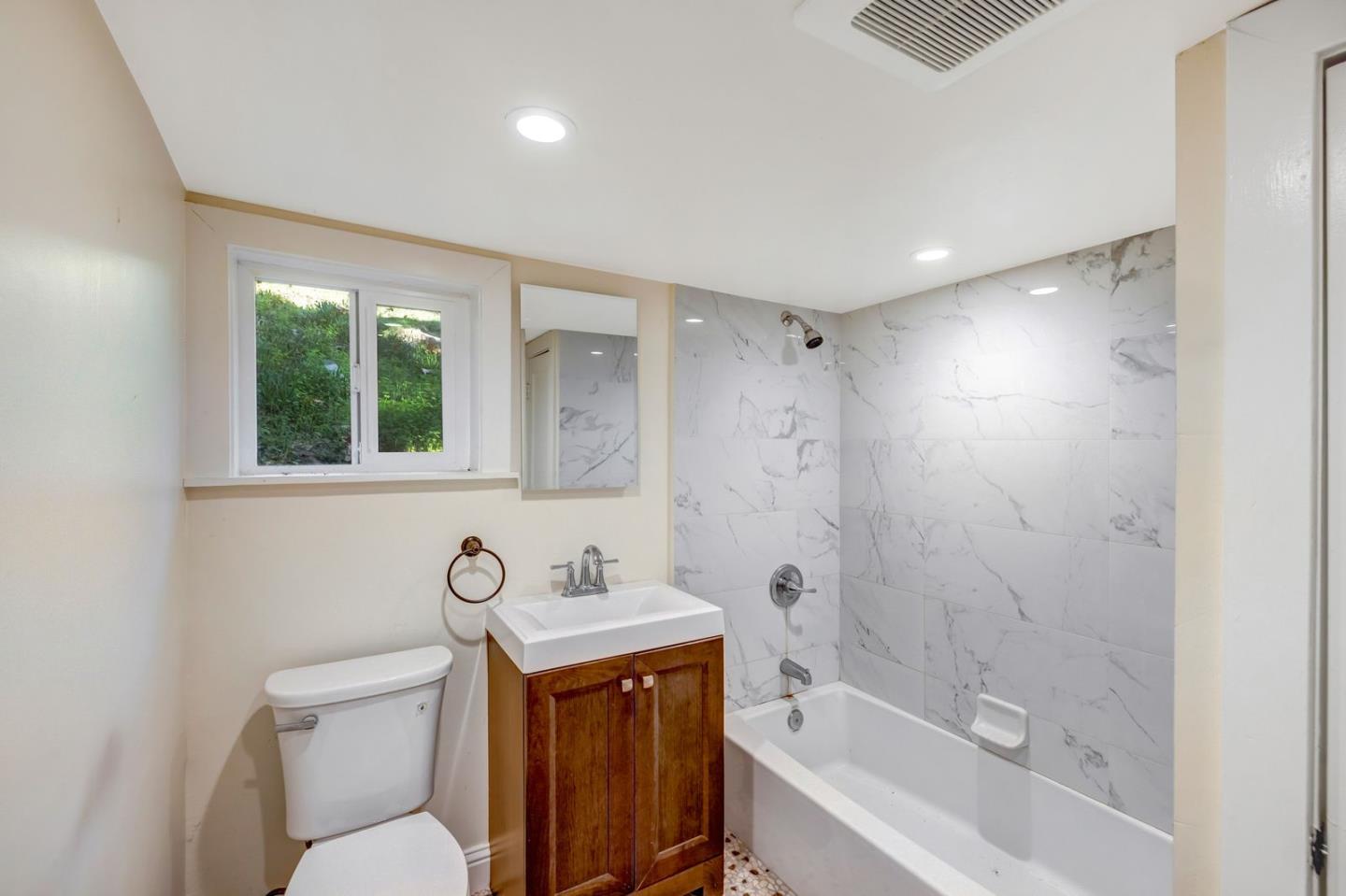 90 Harper Canyon Road Salinas, CA 93908 - Photo 40 of 47 a bathroom with a bath tub sink mirror vanity and toilet