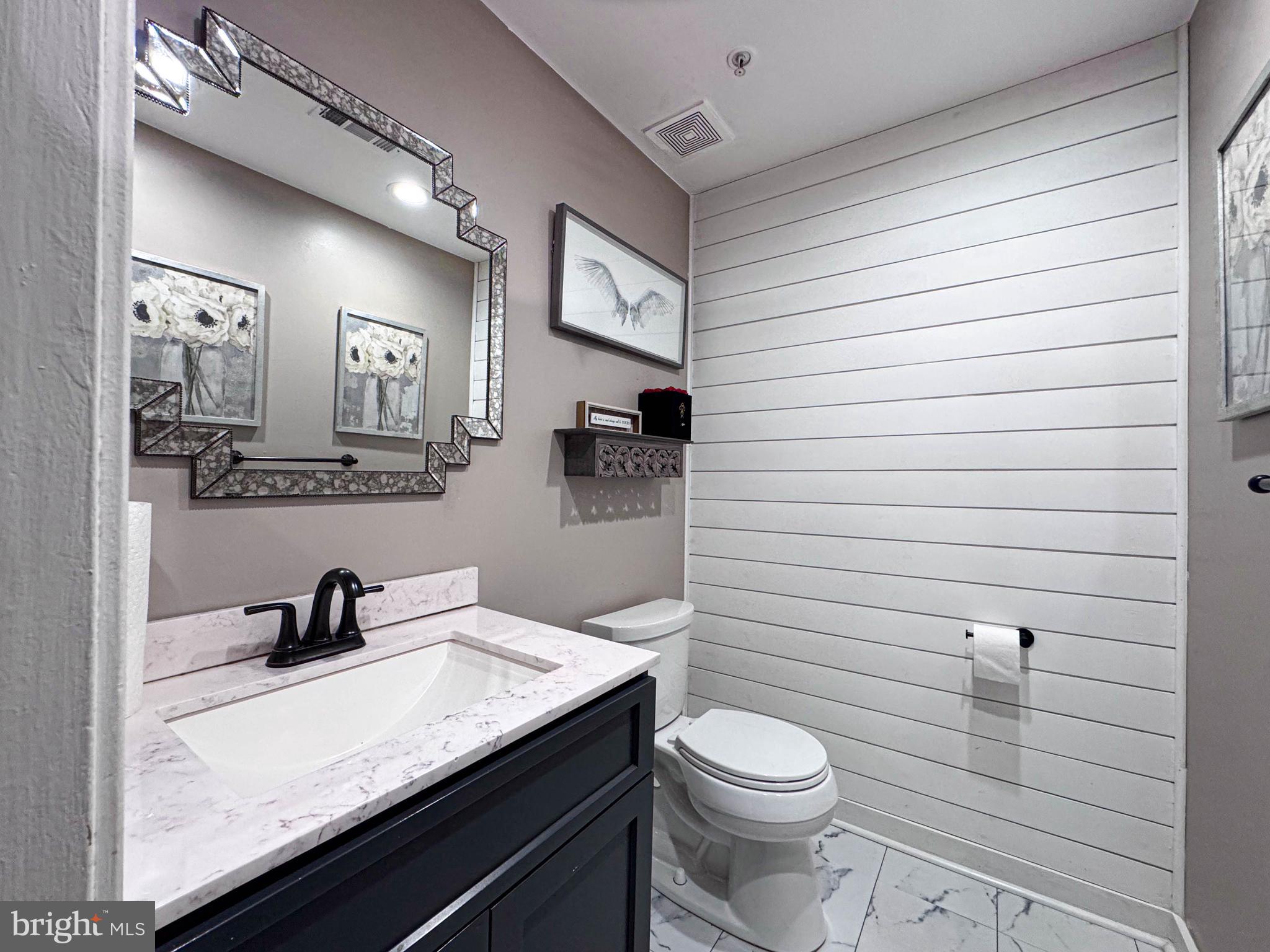 68 Millhaven Court Edgewater, MD 21037 - Photo 14 of 31 a bathroom with a toilet a sink and mirror