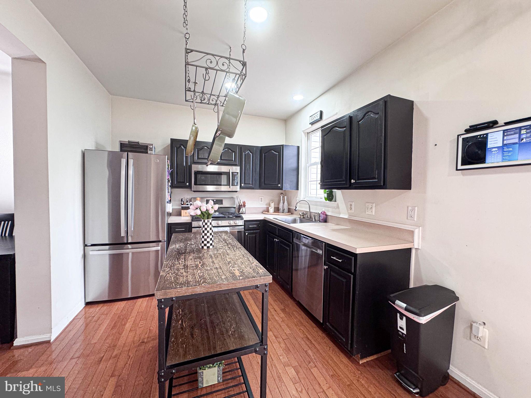 68 Millhaven Court Edgewater, MD 21037 - Photo 17 of 31 a kitchen with kitchen island a counter top space a sink appliances and cabinets