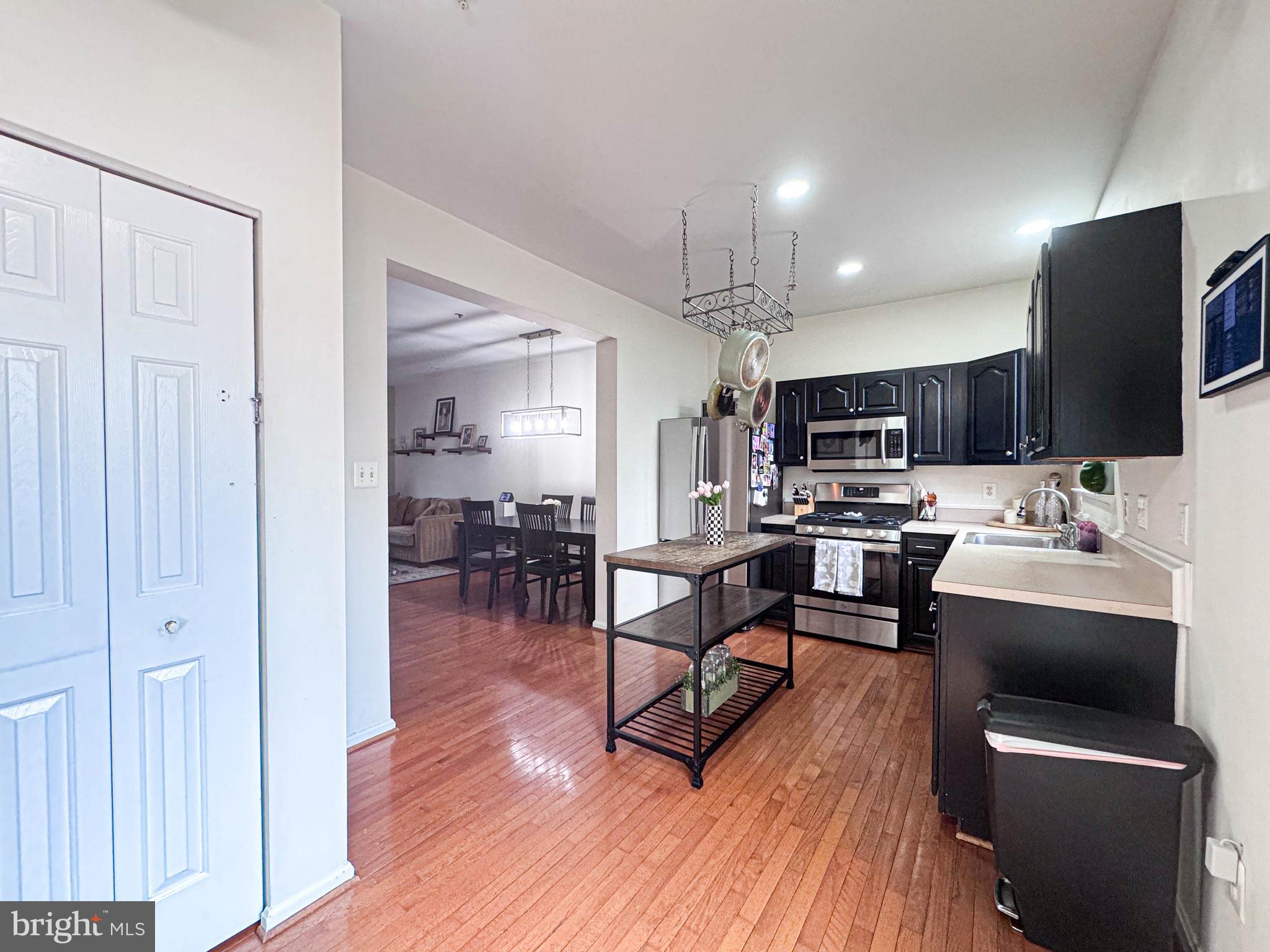 68 Millhaven Court Edgewater, MD 21037 - Photo 18 of 31 a room with stainless steel appliances kitchen island granite countertop a dining table chairs refrigerator and sink