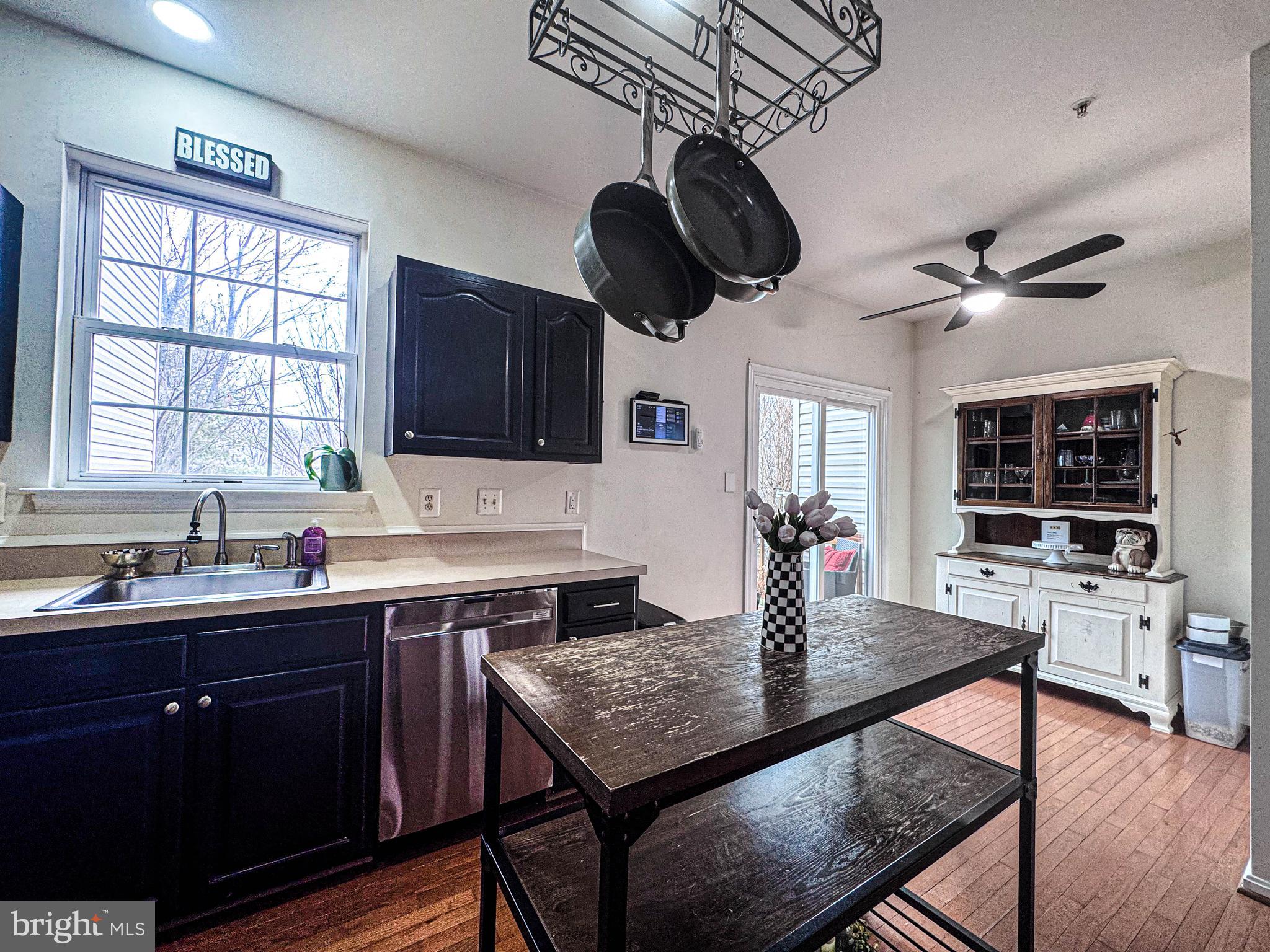 68 Millhaven Court Edgewater, MD 21037 - Photo 19 of 31 a kitchen with a stove a sink a dining table and chairs