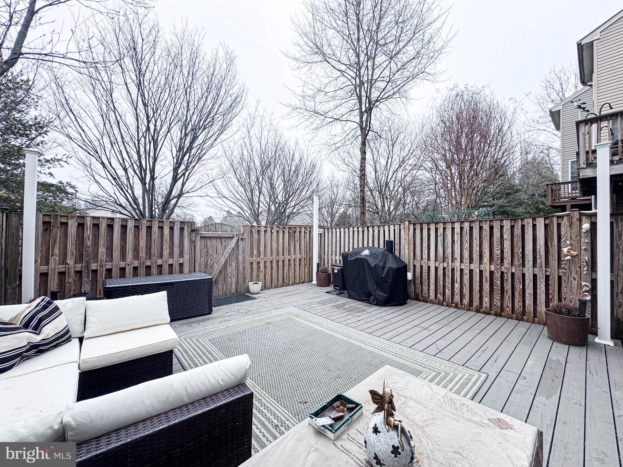 68 Millhaven Court Edgewater, MD 21037 - Photo 2 of 31 a view of a roof deck with couches and wooden fence