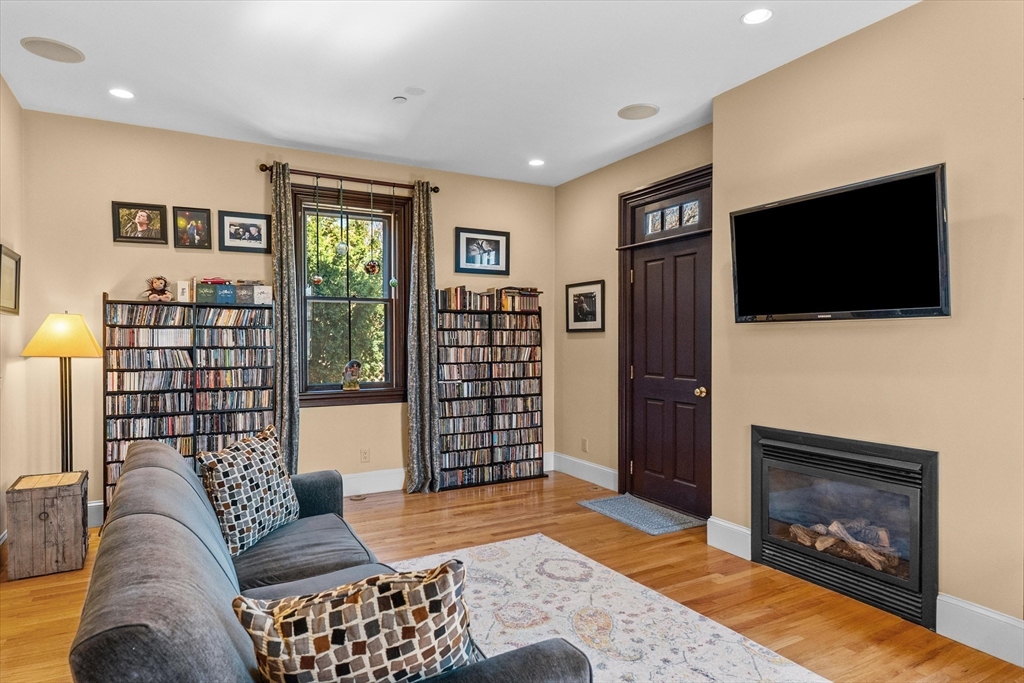 7 Winter Street, Unit 2 Salem, MA 01970 - Photo 12 of 42 a living room with furniture a flat screen tv and a fireplace