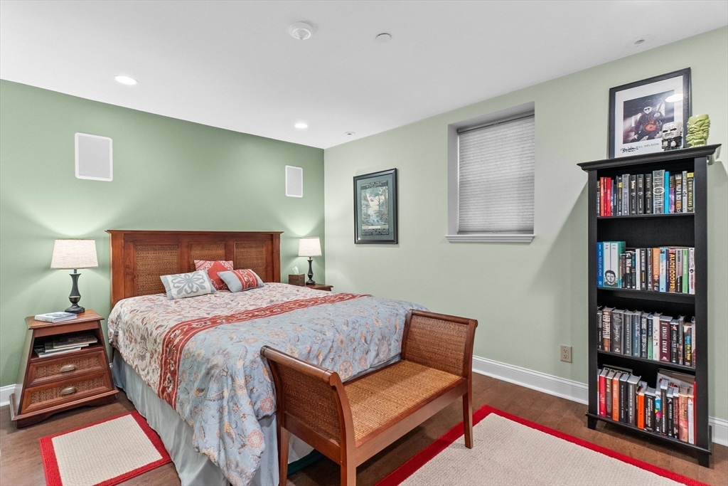 7 Winter Street, Unit 2 Salem, MA 01970 - Photo 17 of 42 a bedroom with a bed a book shelf and a bookshelf