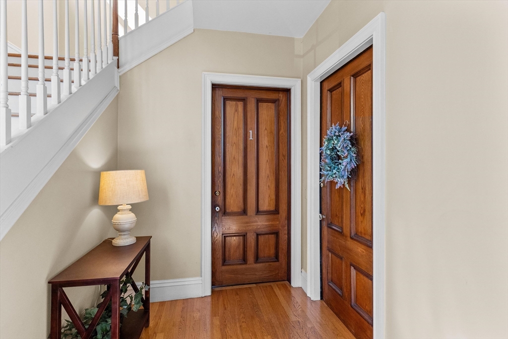 7 Winter Street, Unit 2 Salem, MA 01970 - Photo 5 of 42 a view of a hallway with wooden floor and furniture