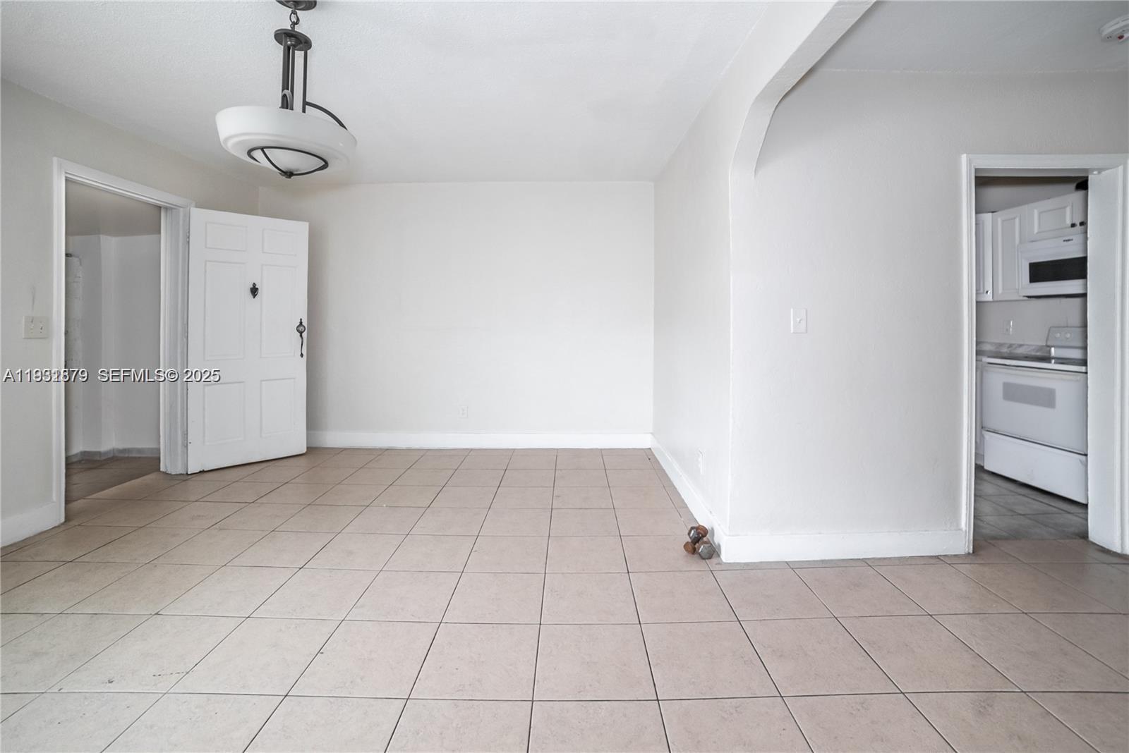 2501 Northwest 22nd Avenue Miami, FL 33142 - Photo 11 of 43 a view of a livingroom with an empty space cabinets and a window