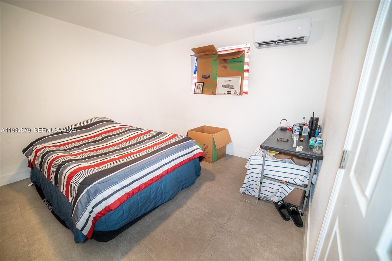 2501 Northwest 22nd Avenue Miami, FL 33142 - Photo 17 of 43 a bedroom with a bed and a cabinets