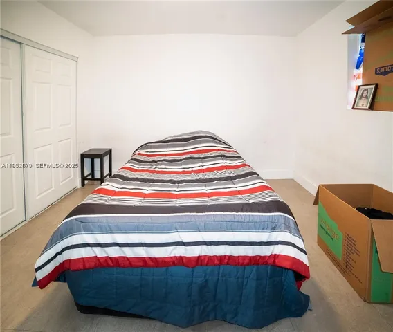 a bedroom with a bed and a table