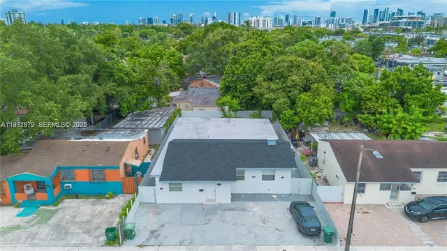 an aerial view of a house with a yard