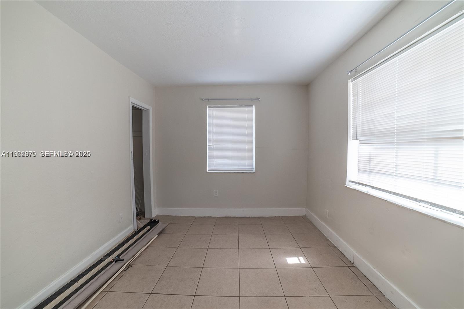 2501 Northwest 22nd Avenue Miami, FL 33142 - Photo 24 of 43 wooden floor in an empty room with a window