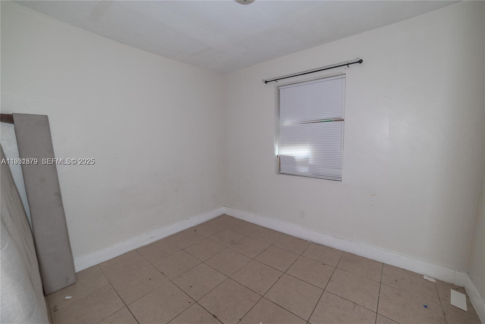 2501 Northwest 22nd Avenue Miami, FL 33142 - Photo 25 of 43 an empty room with a door