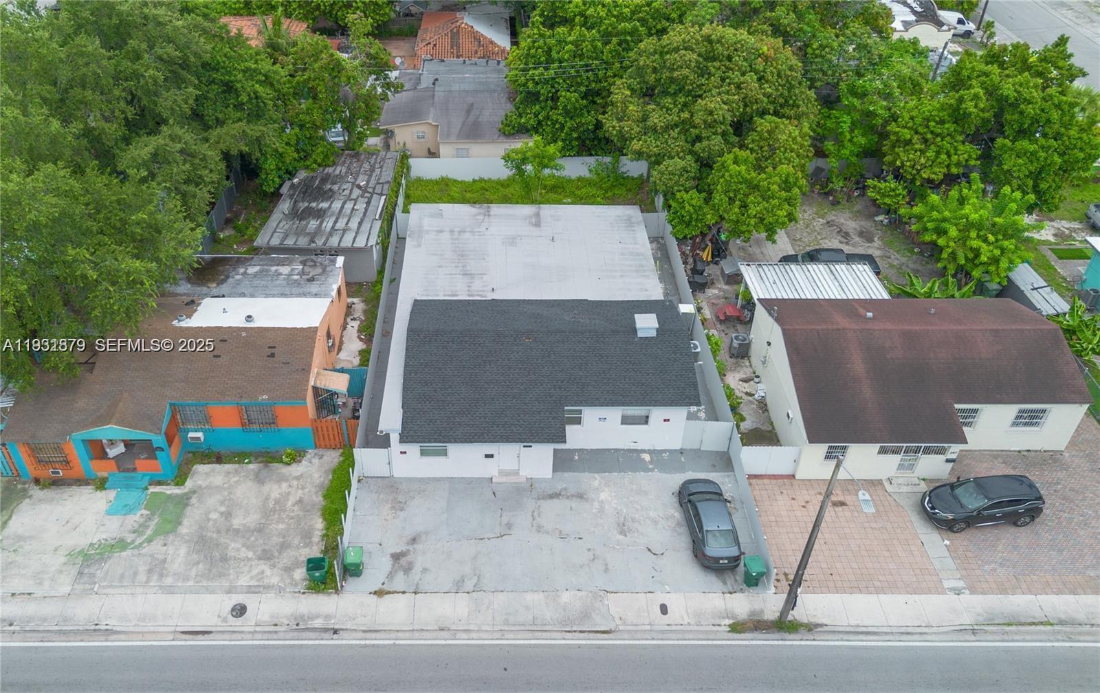 2501 Northwest 22nd Avenue Miami, FL 33142 - Photo 3 of 43 an aerial view of a house with a yard and a garage