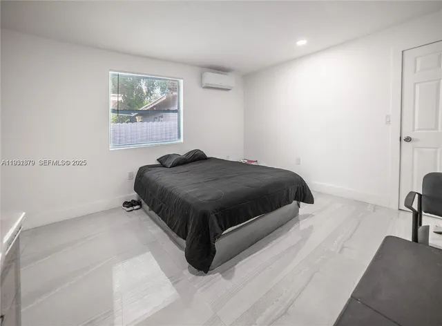 a bedroom with a bed and a couch