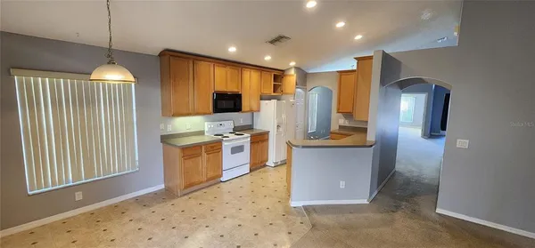 a kitchen with a refrigerator and microwave