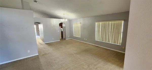 an empty room with closet and windows
