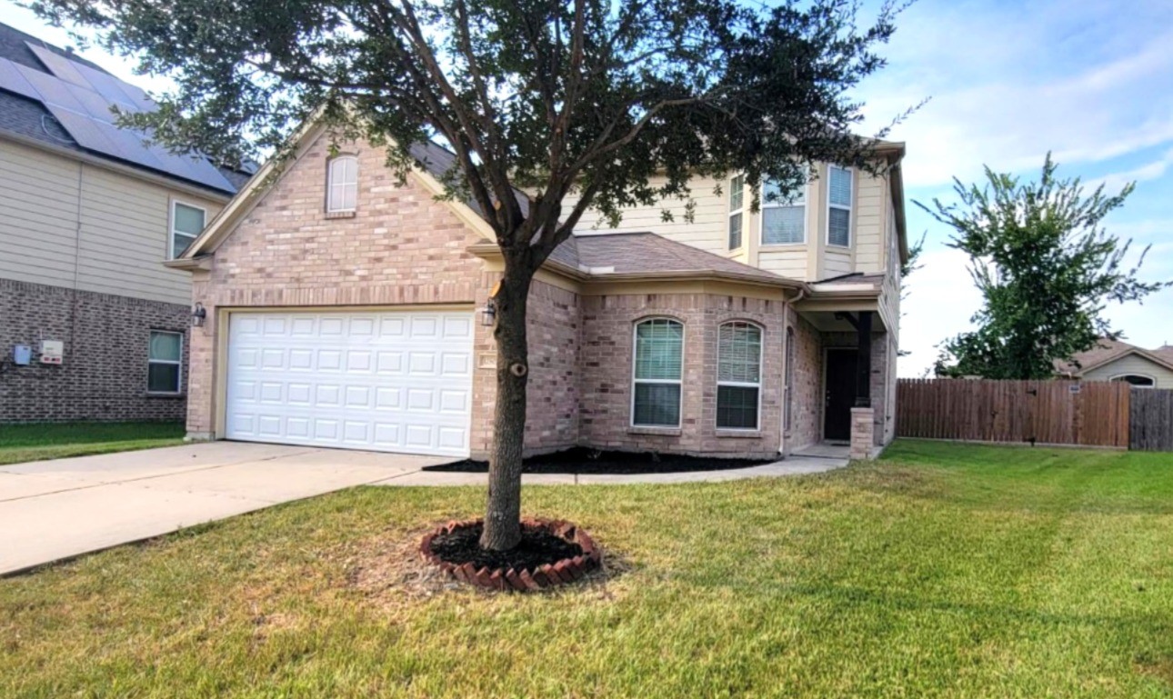 12507 Kings Pond Court Houston, TX 77044 - Photo 2 of 10 a front view of a house with a yard and garage