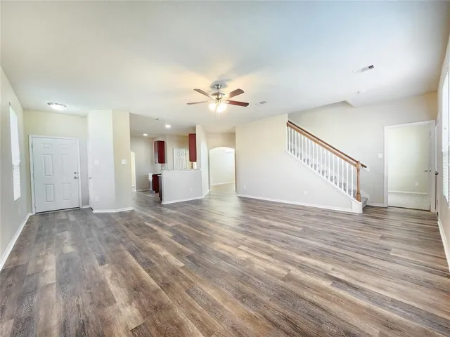 a view of an empty room and wooden floor