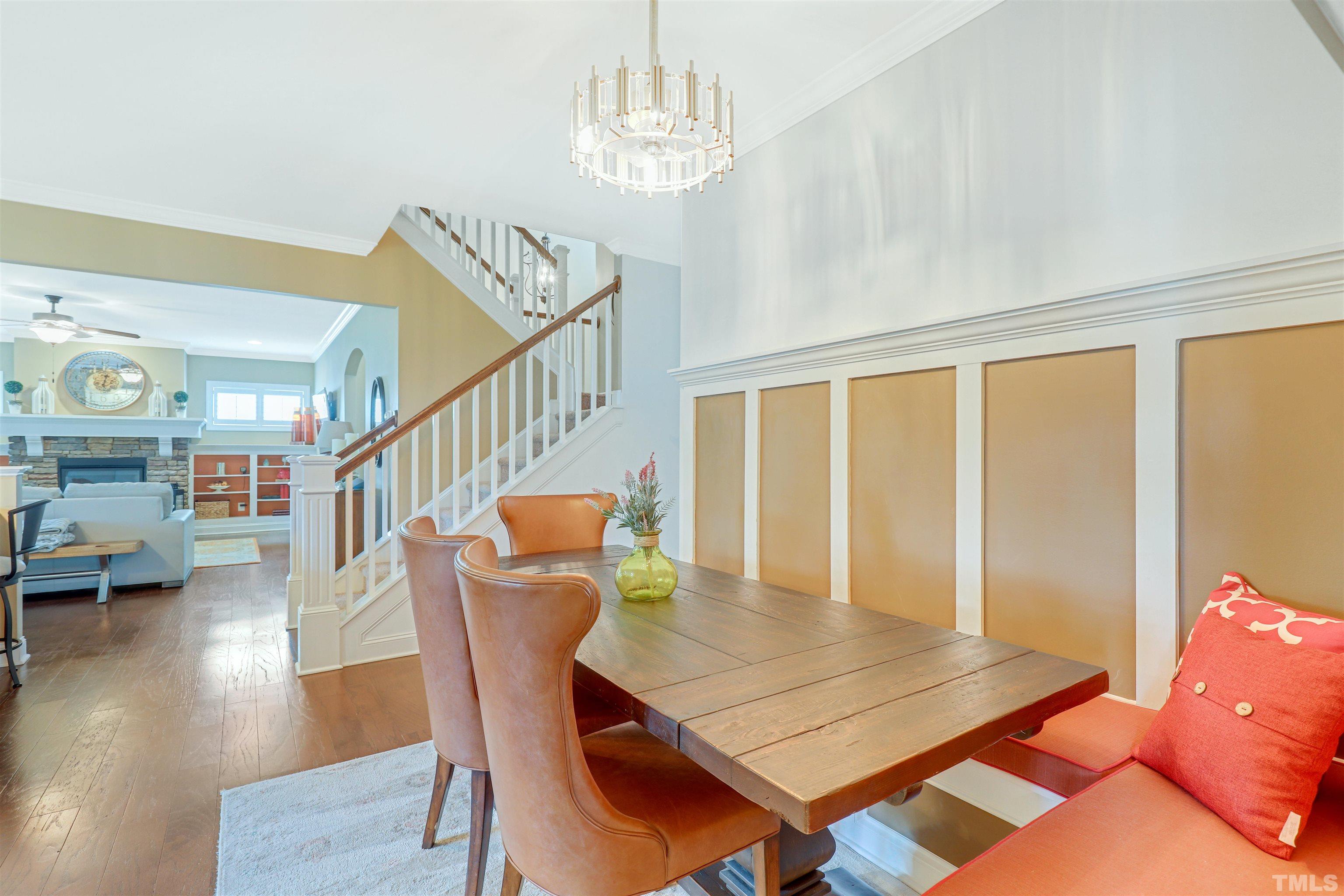 4312 Glengrove Road Raleigh, NC 27616 - Photo 11 of 50 a dining room with furniture wooden floor and a chandelier