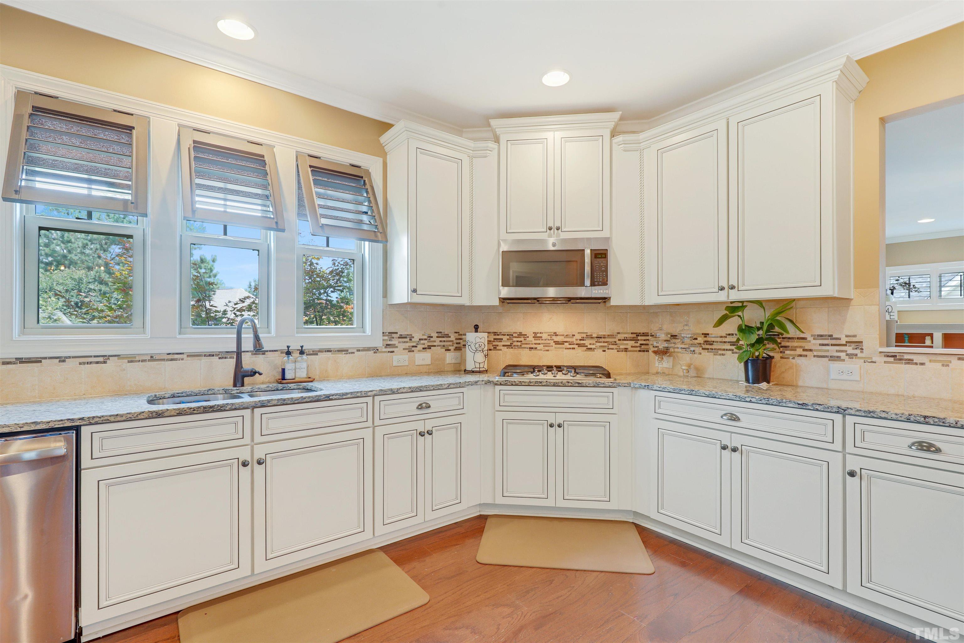4312 Glengrove Road Raleigh, NC 27616 - Photo 12 of 50 a kitchen with white cabinets and sink