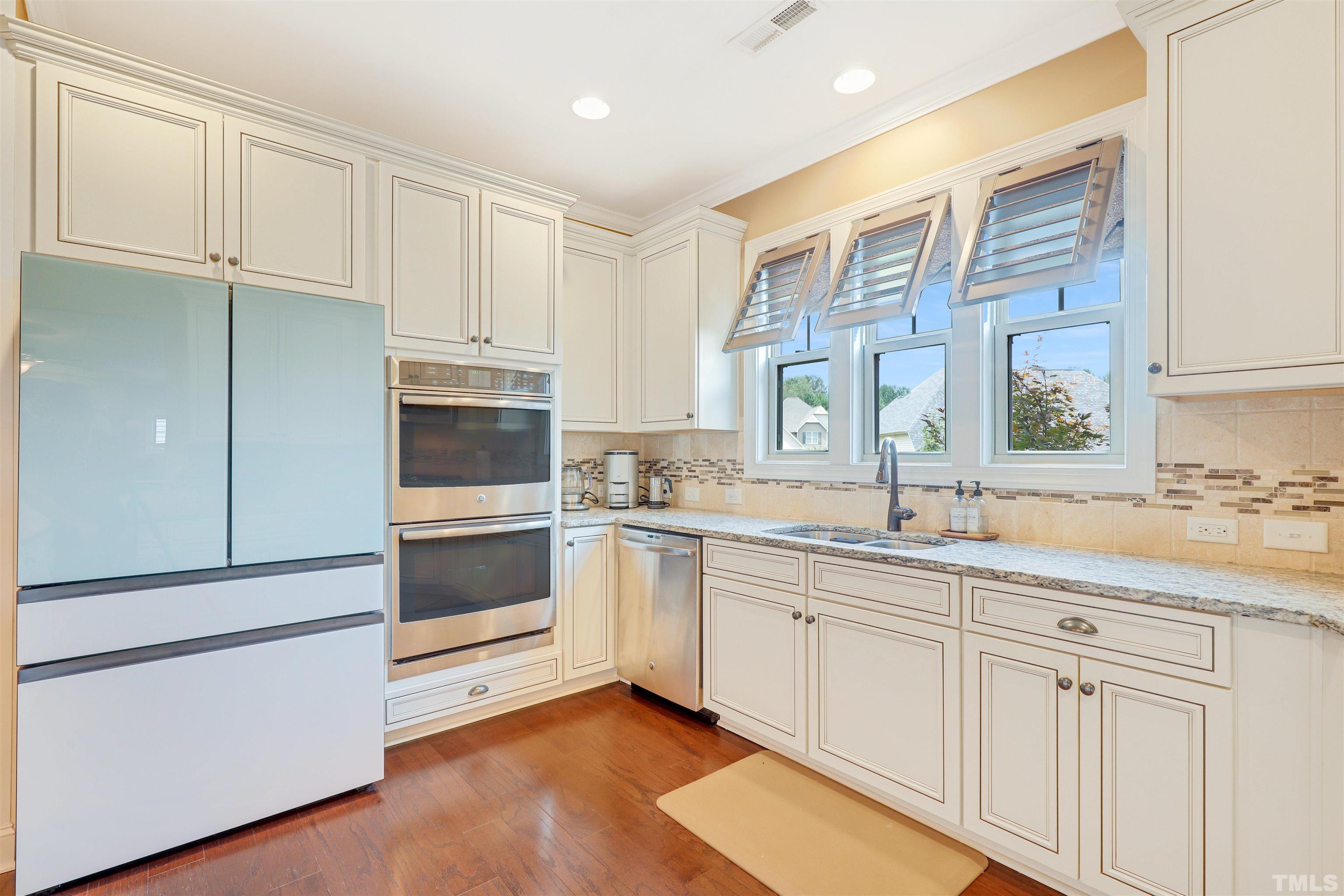 4312 Glengrove Road Raleigh, NC 27616 - Photo 13 of 50 a kitchen with granite countertop white cabinets and white appliances