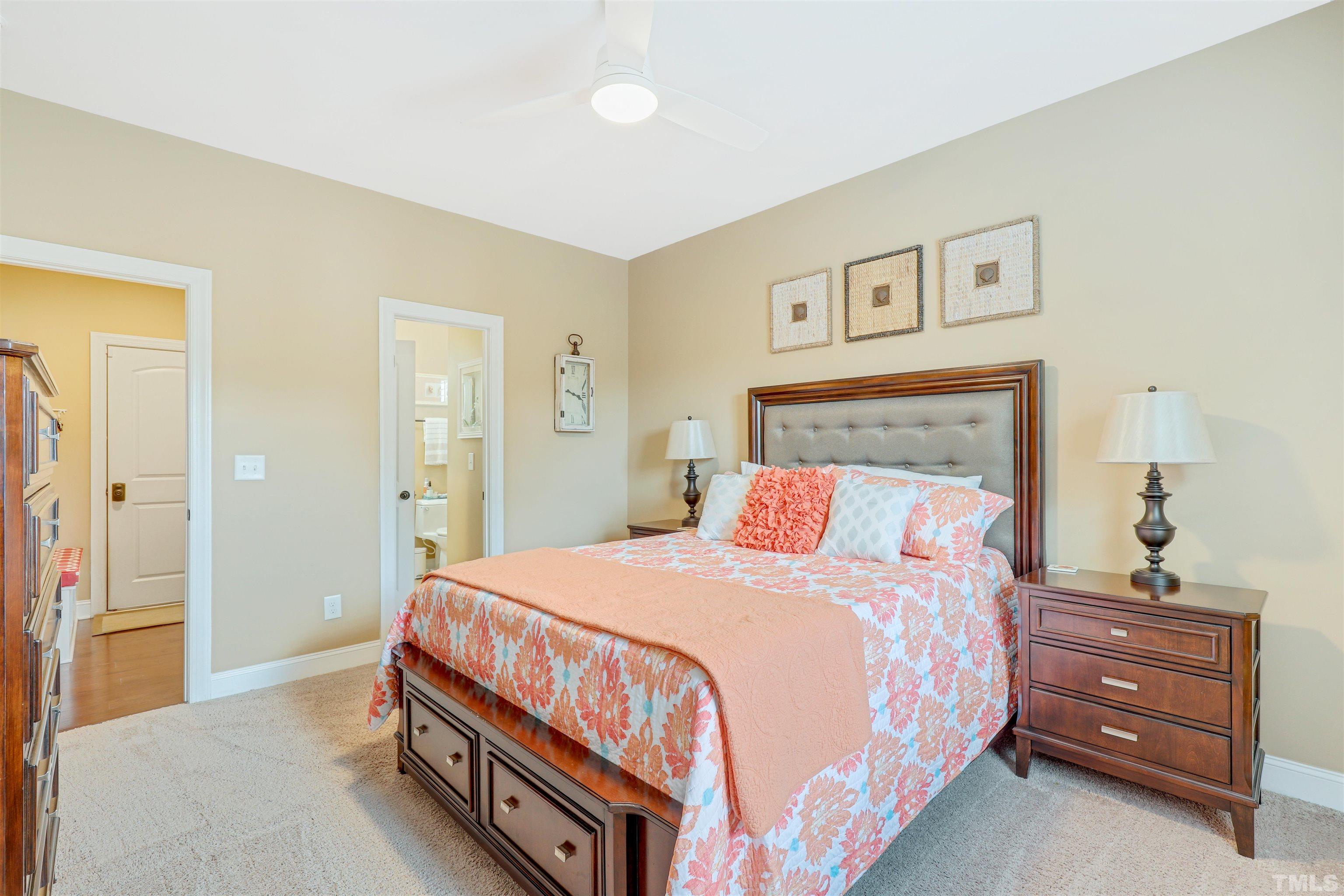 4312 Glengrove Road Raleigh, NC 27616 - Photo 18 of 50 a bedroom with a bed and a lamp