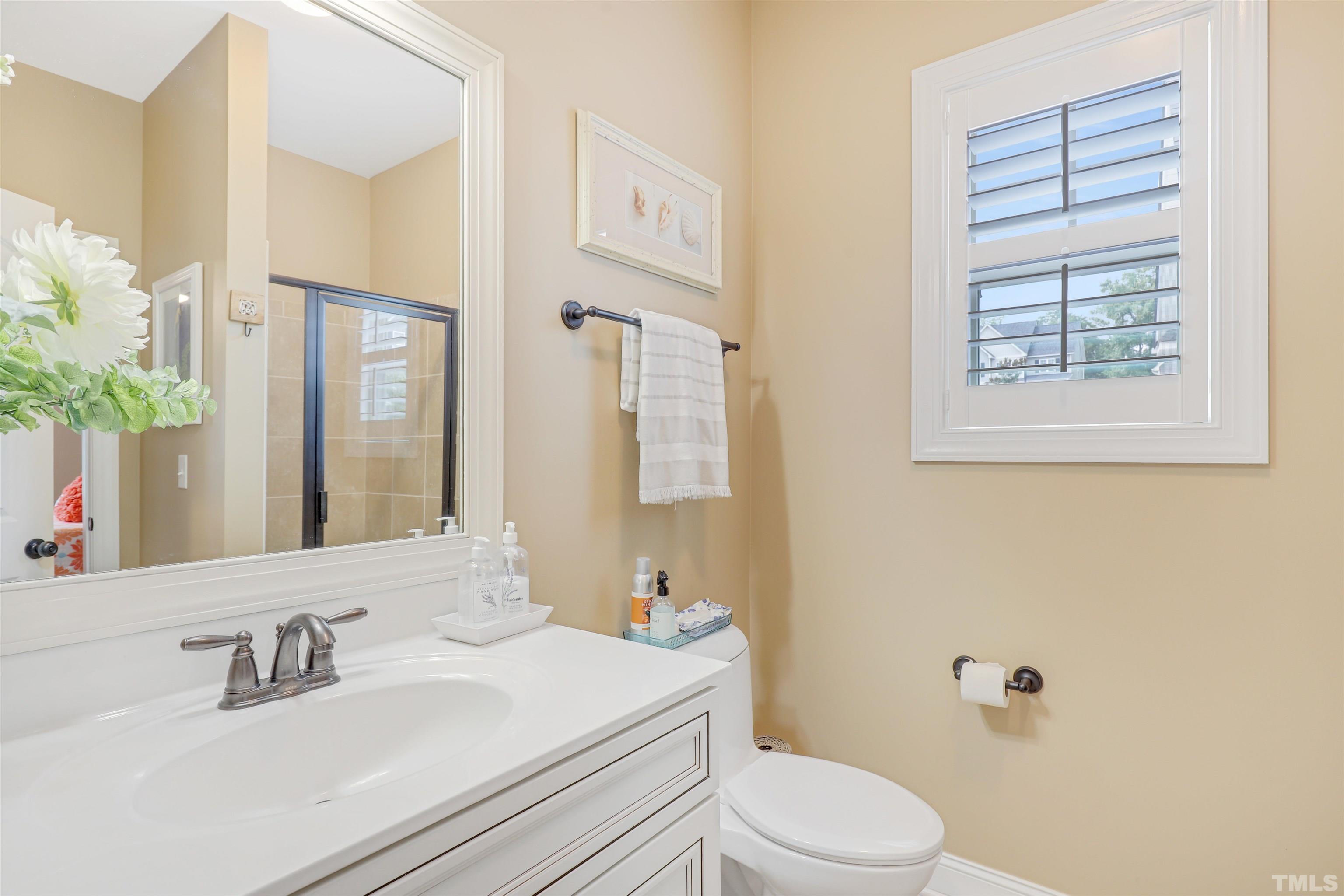 4312 Glengrove Road Raleigh, NC 27616 - Photo 19 of 50 a bathroom with a sink a toilet and a mirror