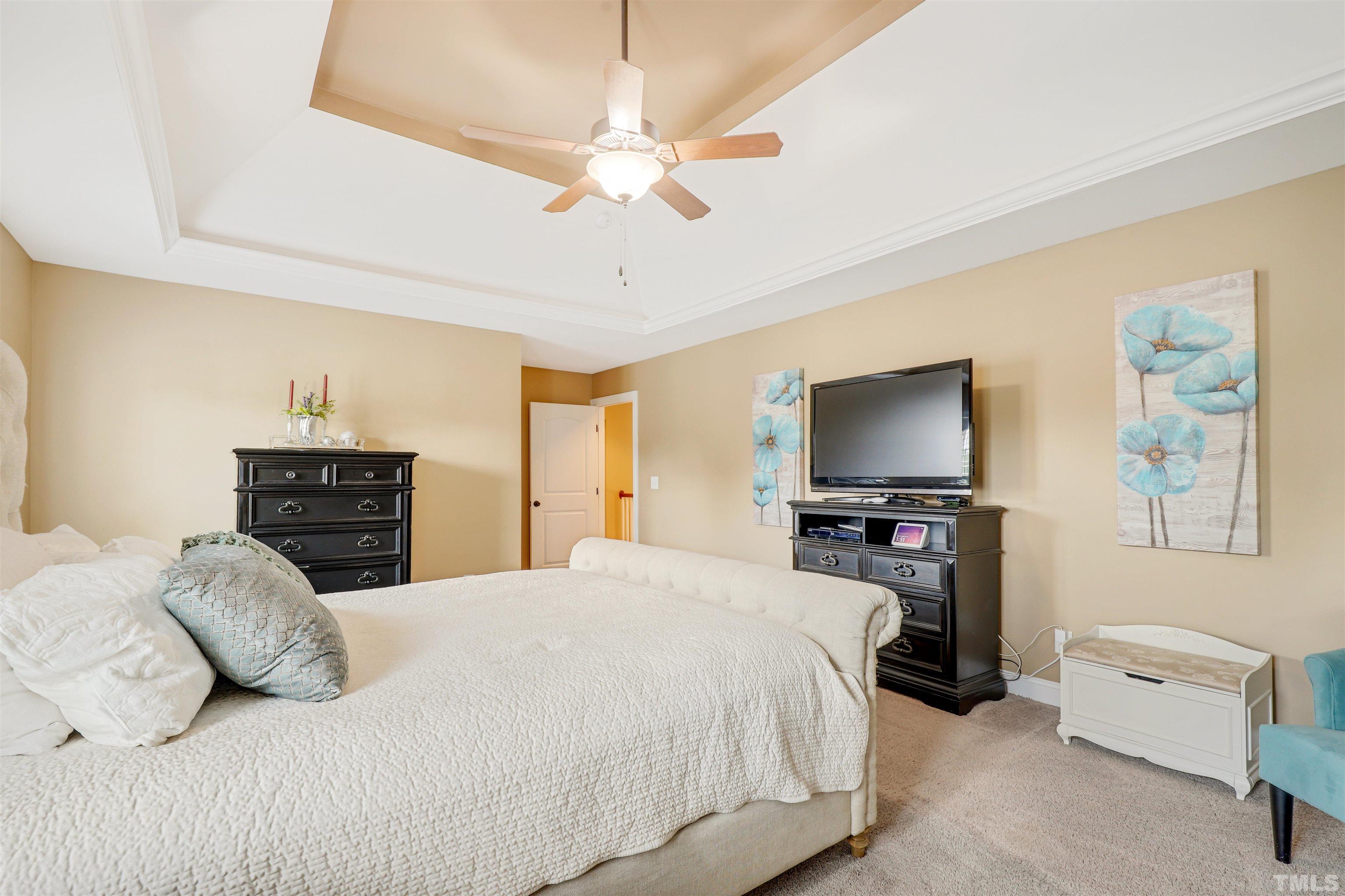 4312 Glengrove Road Raleigh, NC 27616 - Photo 24 of 50 a bedroom with a large bed and a flat tv screen on dresser